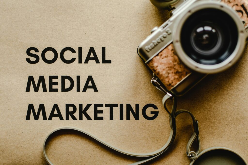 pexels-photo-6956301-6956301 A vintage camera on brown paper with 'SOCIAL MEDIA MARKETING' text, perfect for marketing visuals.